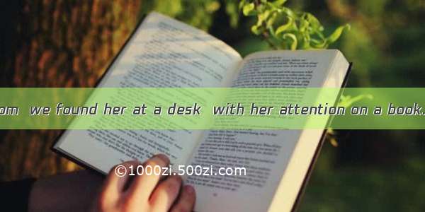 In the reading room  we found her at a desk  with her attention on a book. A. sitting; fix